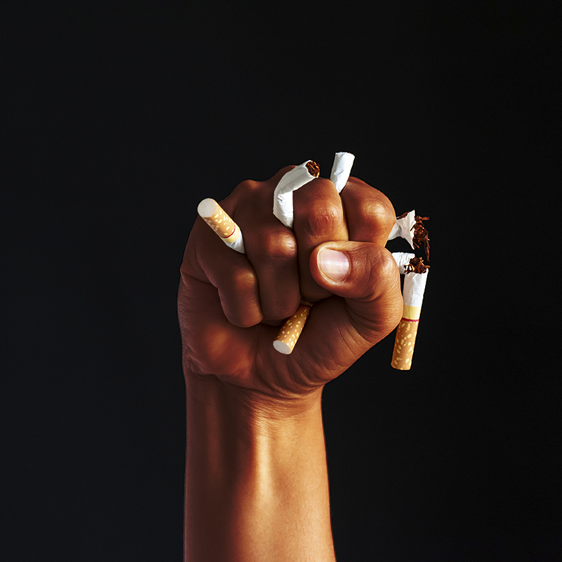 Fist crushing cigarettes