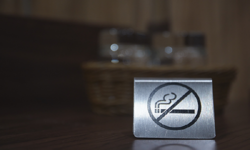 Metal no smoking sign on a table, symbolizing smoke-free space